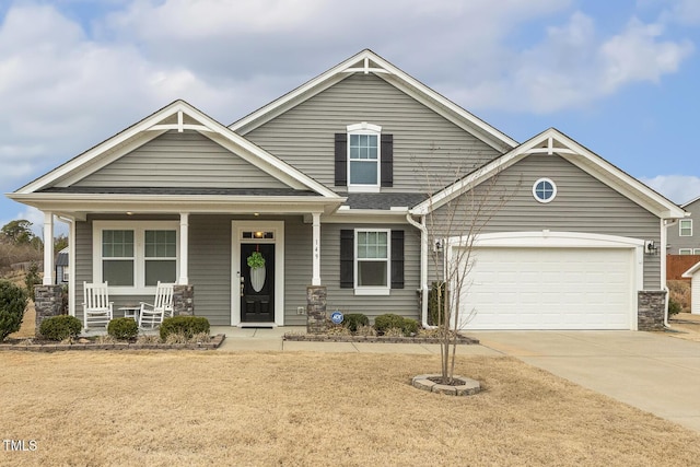 craftsman house featuring driveway, a garage, and a porch