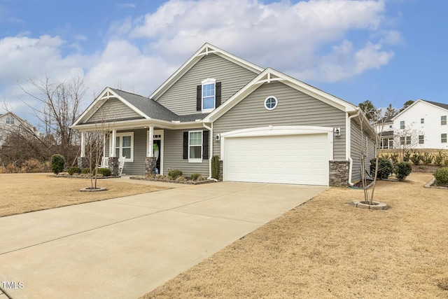 view of front of property featuring a garage, covered porch, and concrete driveway