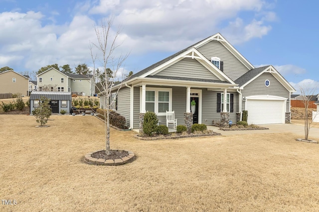 view of front of property with covered porch, driveway, and a garage