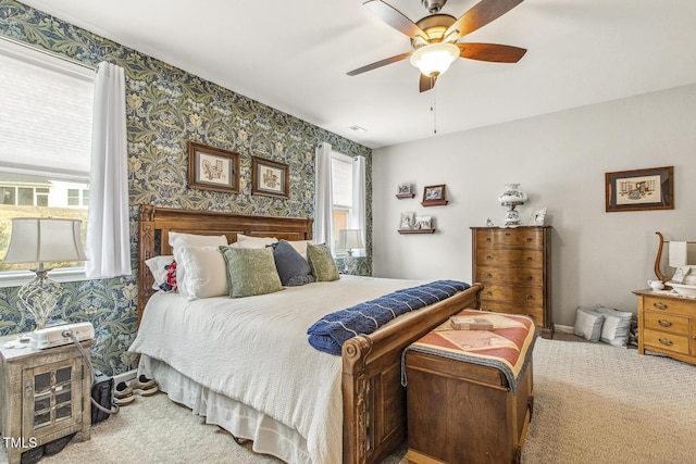 carpeted bedroom with ceiling fan, baseboards, and wallpapered walls