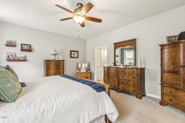 bedroom featuring light colored carpet, ceiling fan, and baseboards