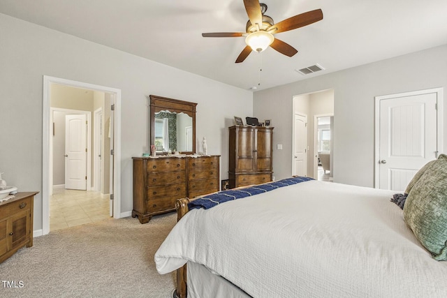 bedroom with baseboards, a ceiling fan, visible vents, and light colored carpet