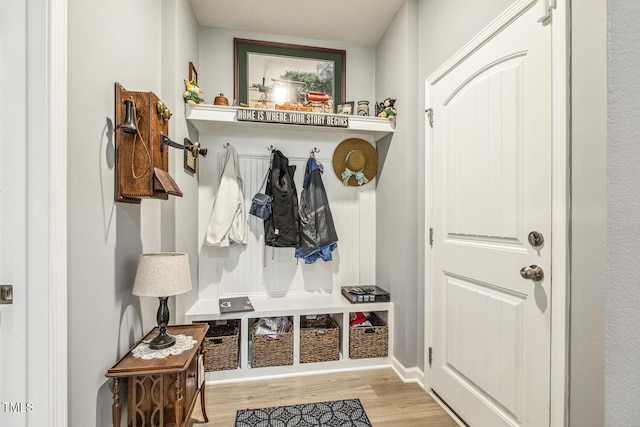 mudroom featuring wood finished floors and baseboards