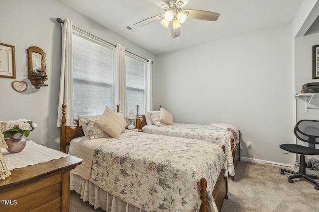 carpeted bedroom featuring visible vents, ceiling fan, and baseboards