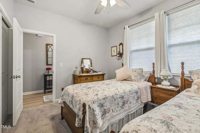 carpeted bedroom featuring ceiling fan and baseboards