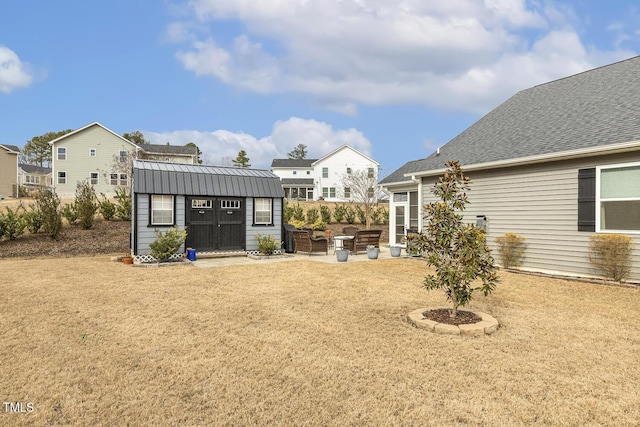 view of yard with a patio area, a storage shed, and an outdoor structure