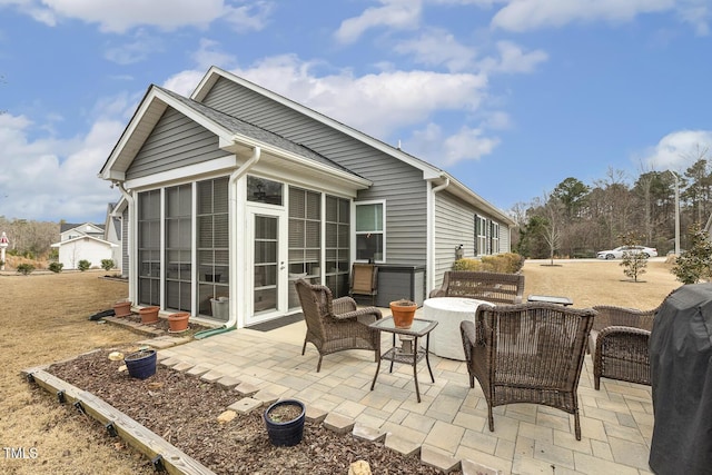 exterior space with an outdoor hangout area, roof with shingles, a patio area, and a sunroom