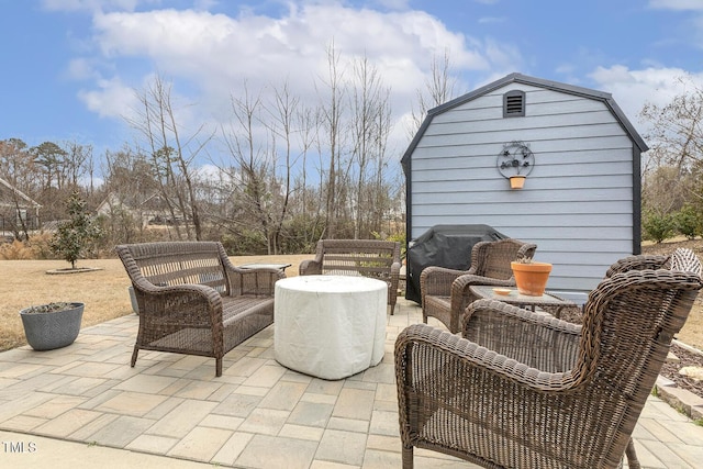 view of patio with an outdoor hangout area and an outbuilding