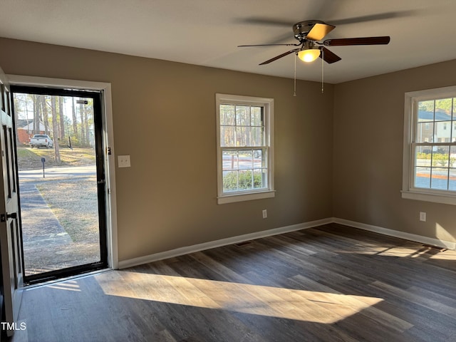 interior space with ceiling fan, baseboards, and dark wood-type flooring