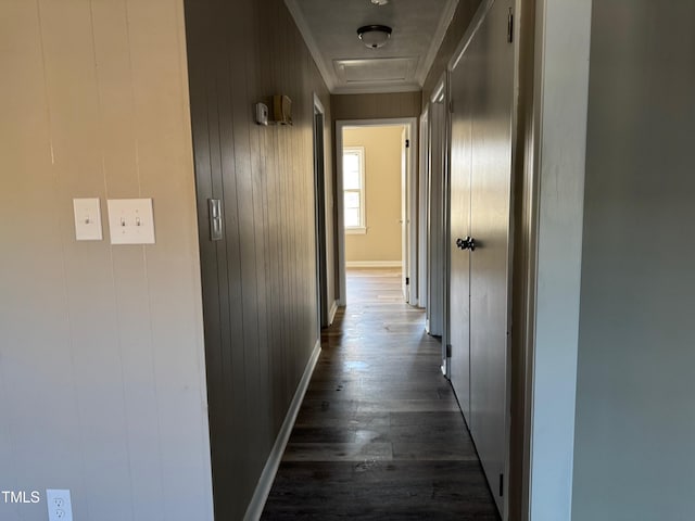 hall featuring dark wood-style flooring and baseboards