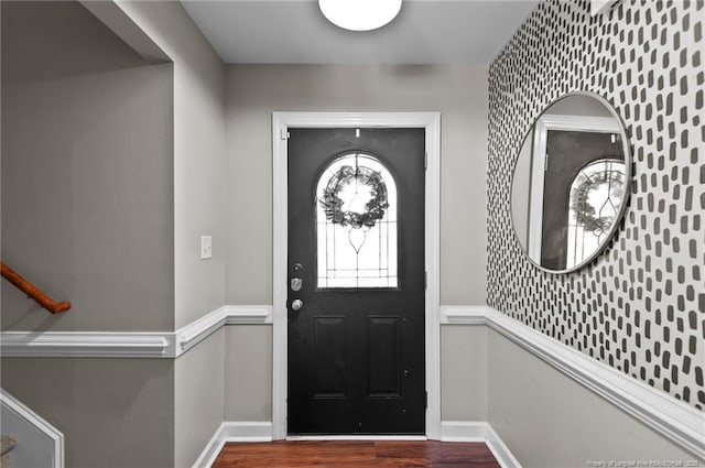 entrance foyer featuring baseboards and wood finished floors