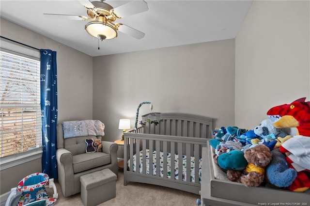 bedroom with light carpet and a ceiling fan