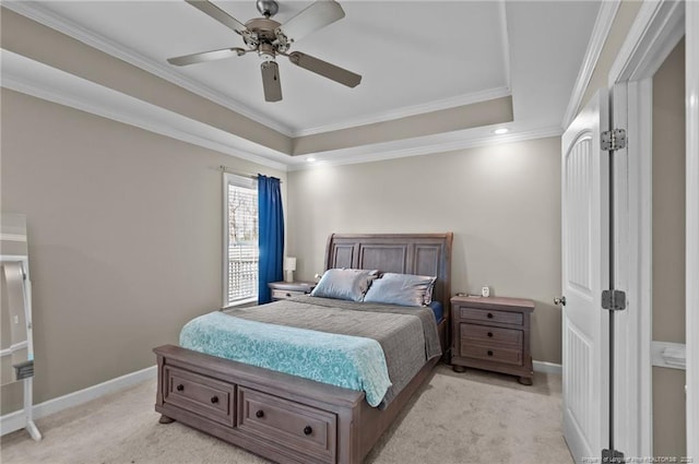 bedroom with baseboards, crown molding, a raised ceiling, and light colored carpet