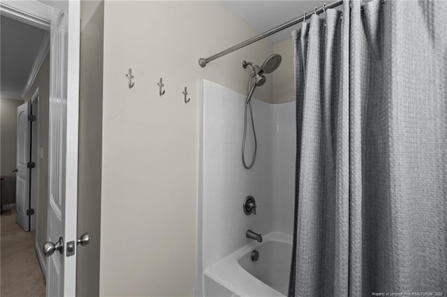 full bathroom featuring ornamental molding and shower / tub combo with curtain