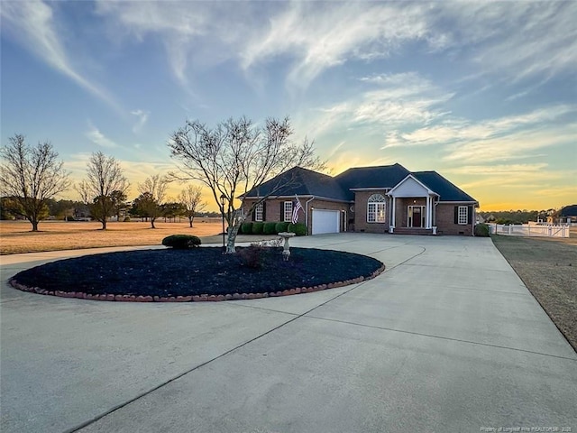 view of front of house featuring curved driveway and an attached garage