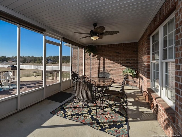 sunroom / solarium with a ceiling fan