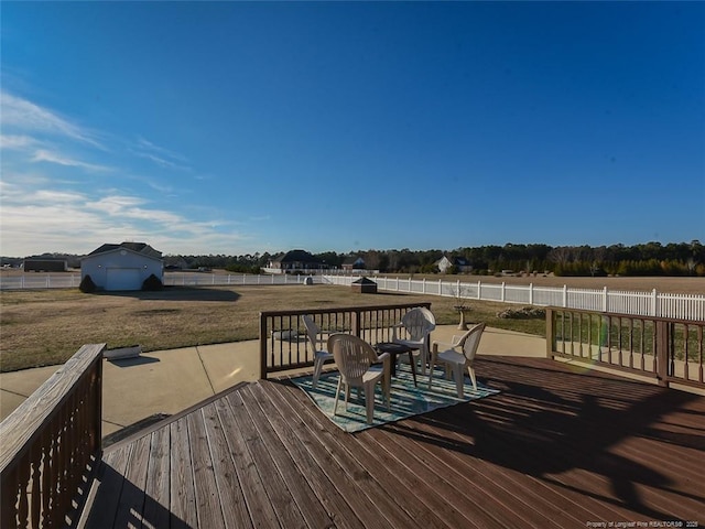 wooden terrace featuring fence and a lawn