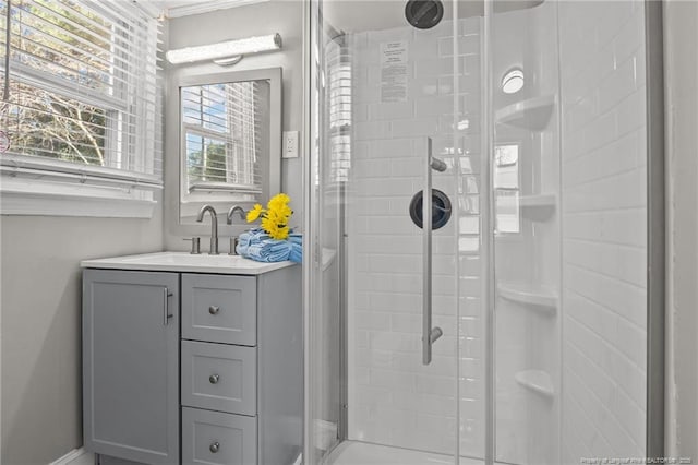 full bath with a stall shower and vanity