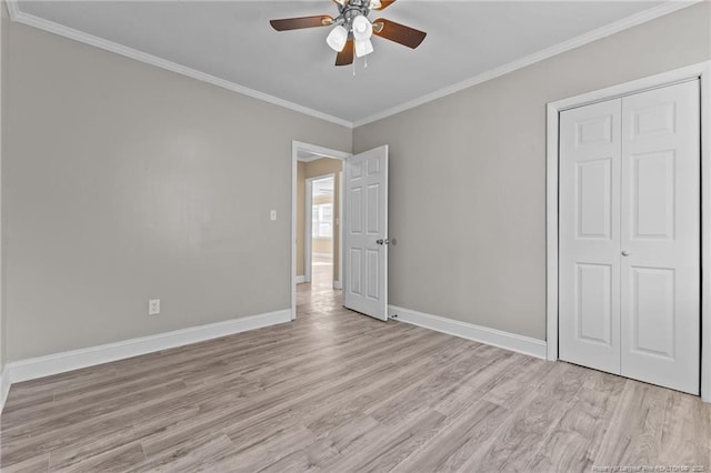 unfurnished bedroom featuring ornamental molding, baseboards, ceiling fan, and light wood finished floors