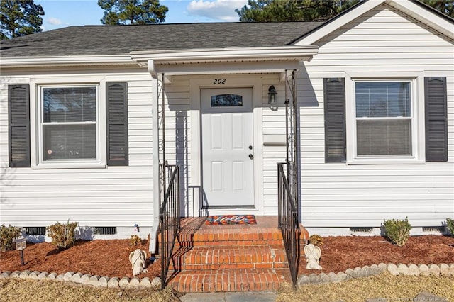 doorway to property with roof with shingles and crawl space