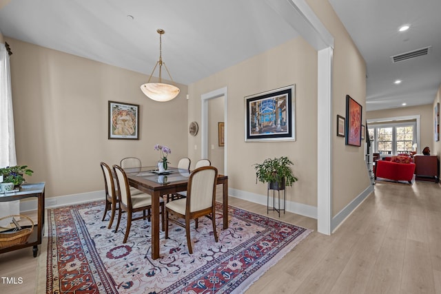 dining room with light wood-style flooring, visible vents, baseboards, and recessed lighting