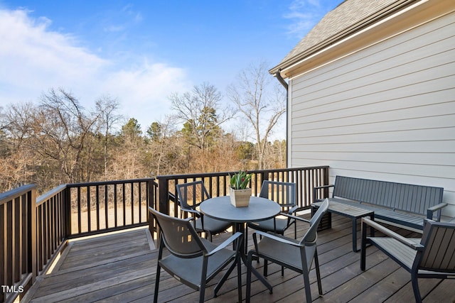 wooden terrace featuring outdoor dining space