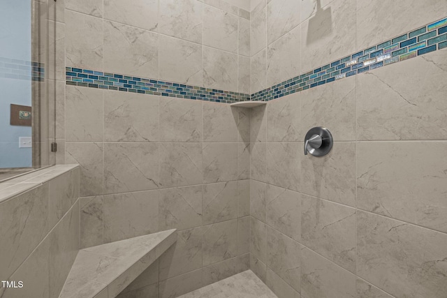 full bath featuring tiled shower