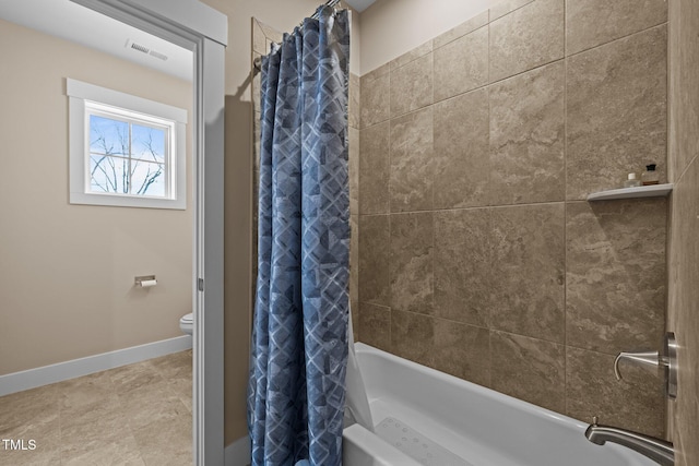 bathroom featuring shower / bath combo, visible vents, toilet, and baseboards