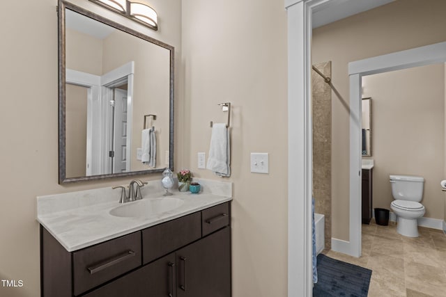 bathroom featuring toilet, vanity, baseboards,  shower combination, and tile patterned floors