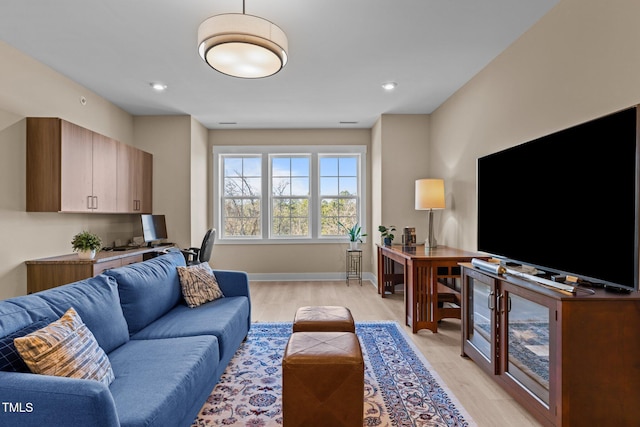 living area featuring recessed lighting, baseboards, and light wood finished floors