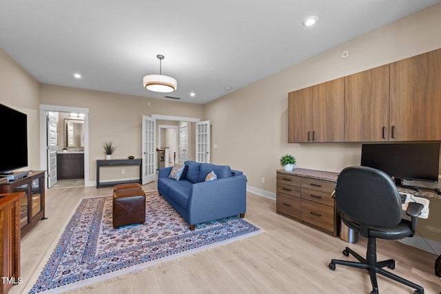 office space featuring light wood-style floors, baseboards, visible vents, and recessed lighting