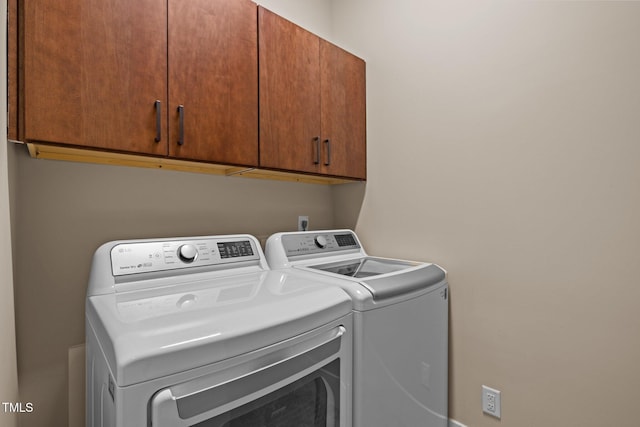 laundry area featuring cabinet space and washing machine and dryer