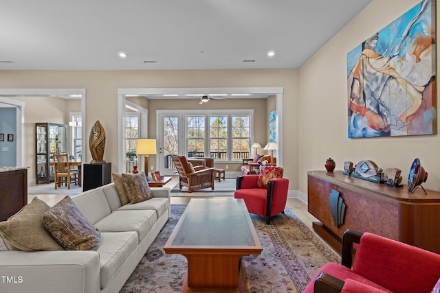 living area featuring baseboards, a ceiling fan, and recessed lighting