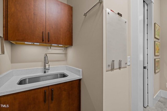 kitchen with a sink and light stone countertops