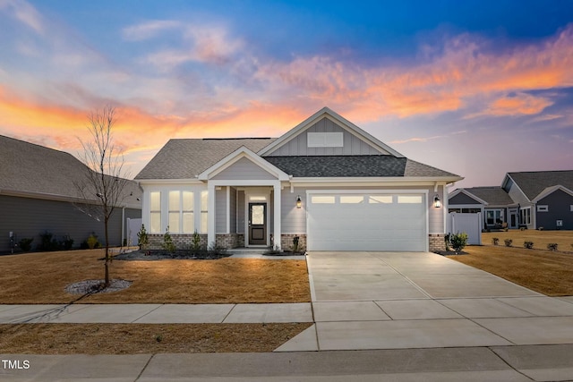 view of front of property featuring a garage, concrete driveway, brick siding, and board and batten siding