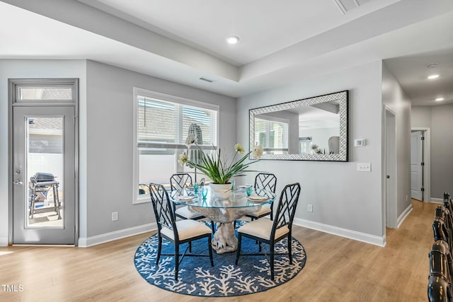 dining room featuring light wood-style floors, visible vents, baseboards, and recessed lighting