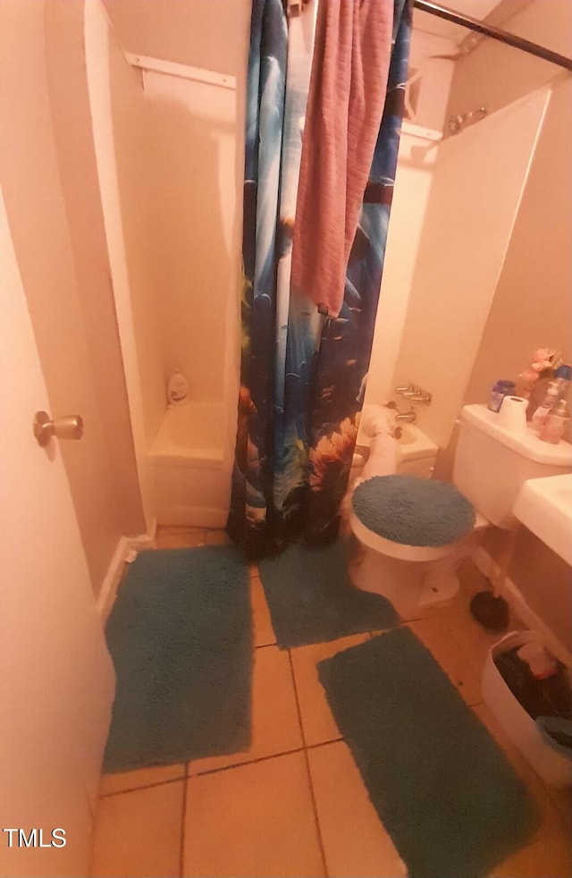 bathroom with toilet, tile patterned flooring, and shower / bath combination with curtain