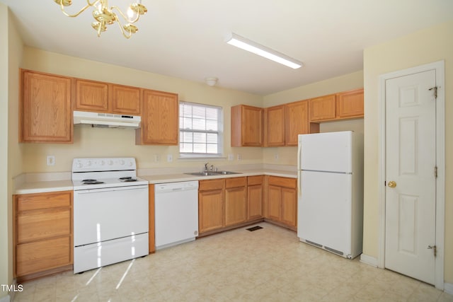 kitchen with under cabinet range hood, white appliances, a sink, light countertops, and light floors