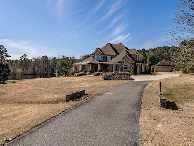 view of front facade featuring a garage and stone siding