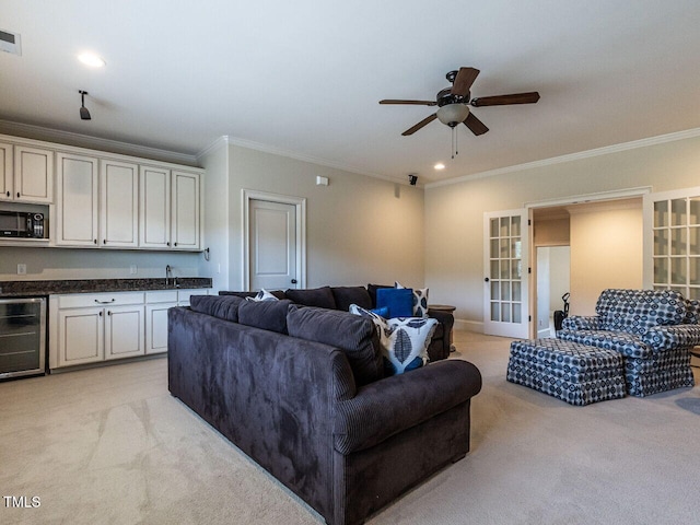 living room with light carpet, wine cooler, visible vents, and crown molding