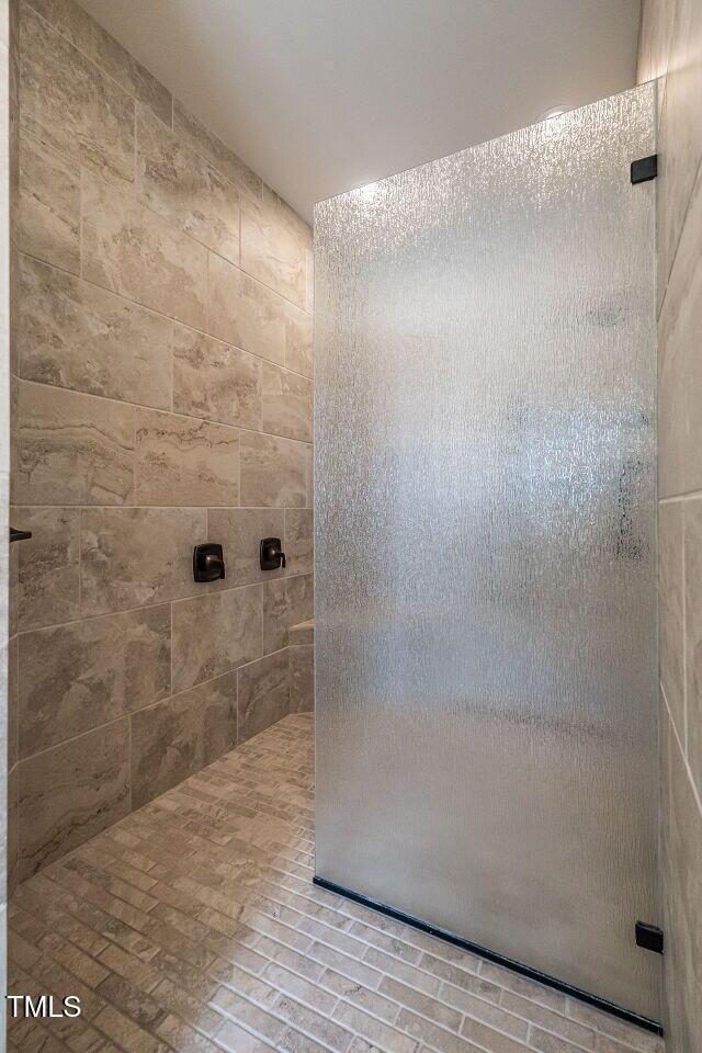 full bathroom with a tile shower