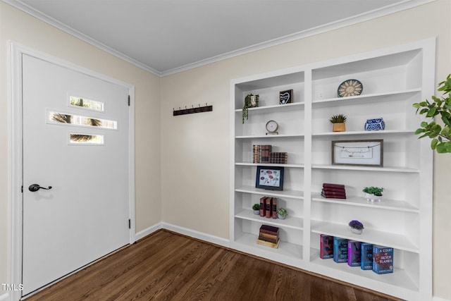 interior space featuring dark wood-style floors, baseboards, built in shelves, and ornamental molding