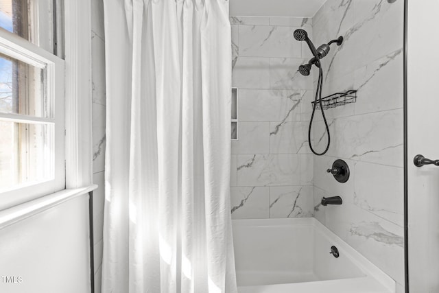 bathroom with shower / bath combination with curtain