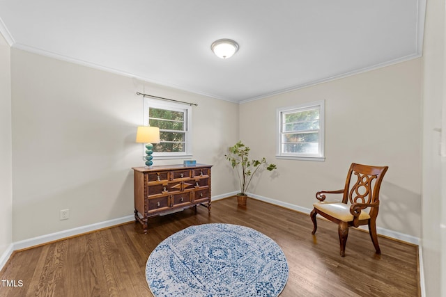 sitting room with a wealth of natural light, baseboards, and wood finished floors