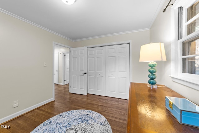 interior space featuring crown molding, baseboards, and wood finished floors