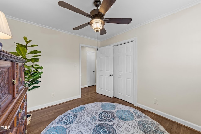 bedroom with baseboards, wood finished floors, and ornamental molding