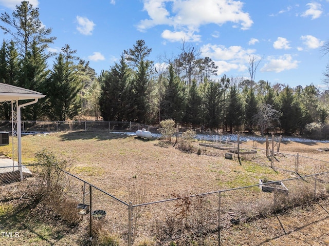 view of yard with fence and central AC unit