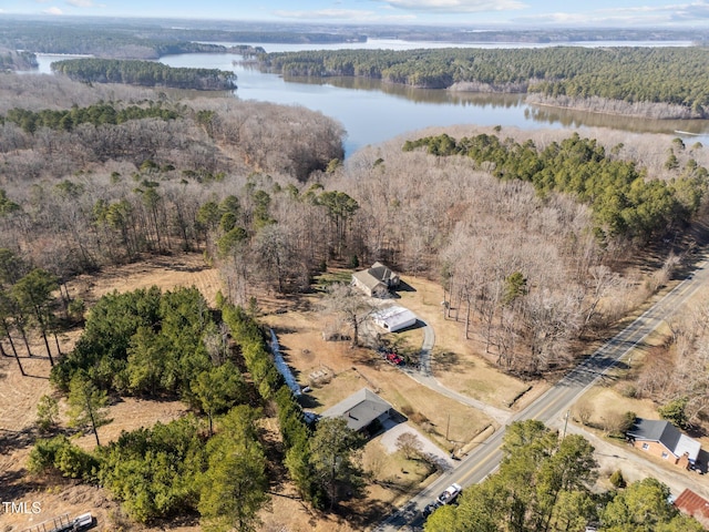 drone / aerial view with a water view and a wooded view