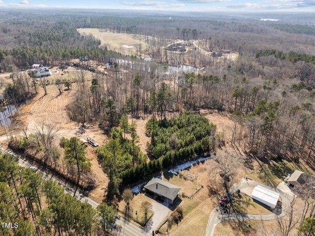 birds eye view of property featuring a wooded view