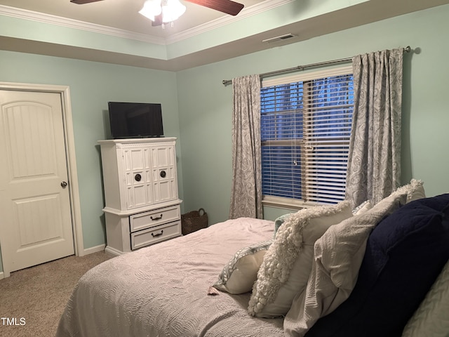 bedroom with carpet flooring, a ceiling fan, visible vents, baseboards, and ornamental molding